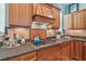 Lovely kitchen showcasing wood cabinetry, granite countertops, backsplash, and modern appliances for culinary enthusiasts at 1326 Apollo Beach S Blvd, Apollo Beach, FL 33572
