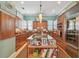 Spacious kitchen featuring wood cabinets, granite countertops, stainless steel appliances, and a charming central island at 1326 Apollo Beach S Blvd, Apollo Beach, FL 33572