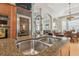 A well-equipped kitchen boasting stainless steel appliances, granite counters, and a center island with a double sink at 1326 Apollo Beach S Blvd, Apollo Beach, FL 33572