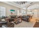 Spacious living room with tray ceiling, neutral paint, and access to dining room at 1326 Apollo Beach S Blvd, Apollo Beach, FL 33572