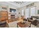 Cozy living room with hardwood floors, fireplace, TV, and comfortable leather furniture for relaxation and entertainment at 1326 Apollo Beach S Blvd, Apollo Beach, FL 33572