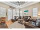 Inviting living room with hardwood floors, large windows, comfortable leather furniture, and stylish decor at 1326 Apollo Beach S Blvd, Apollo Beach, FL 33572