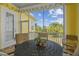 Relaxing screened-in patio with seating, string lights, and a view of the backyard at 1326 Apollo Beach S Blvd, Apollo Beach, FL 33572