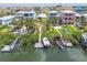 Bright waterfront homes feature private docks and boat lifts on a canal with mature landscaping at 1326 Apollo Beach S Blvd, Apollo Beach, FL 33572