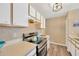 Bright kitchen featuring white cabinets, modern appliances, and laminate wood flooring at 1333 Twilridge Pl, Brandon, FL 33511