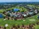 Stunning aerial view of home on golf course with lush landscaping and water features at 16 Hibiscus Rd, Belleair, FL 33756