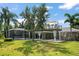 The house features an upper patio and backyard with lush greenery, creating an inviting outdoor space at 16 Hibiscus Rd, Belleair, FL 33756