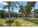 Expansive backyard view featuring a swimming pool, patio area and an upper deck at 16 Hibiscus Rd, Belleair, FL 33756