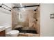 Elegant bathroom features a modern glass shower with marble tile, built-in bench, and black fixtures at 16 Hibiscus Rd, Belleair, FL 33756