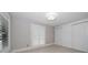 This light and airy bedroom offers ample closet space and bright, natural light from shuttered windows at 16 Hibiscus Rd, Belleair, FL 33756