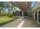 Outdoor deck overlooking backyard with screened-in pool, offering a tranquil and private outdoor space at 16 Hibiscus Rd, Belleair, FL 33756
