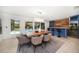 Open-concept dining area featuring a built-in bar, stylish lighting, and seamless access to the outdoor pool area at 16 Hibiscus Rd, Belleair, FL 33756