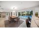 Elegant dining area with access to backyard, stylish lighting, and room for seating at 16 Hibiscus Rd, Belleair, FL 33756