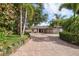 Beautiful home exterior featuring a brick driveway, lush landscaping, and inviting entrance at 16 Hibiscus Rd, Belleair, FL 33756