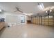 Spacious garage with epoxy floors, storage cabinets, and two garage doors at 16 Hibiscus Rd, Belleair, FL 33756