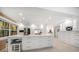 Spacious white kitchen with large island, counter seating, and stainless steel appliances at 16 Hibiscus Rd, Belleair, FL 33756