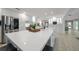 Spacious kitchen with a large white countertop island and stainless steel appliances at 16 Hibiscus Rd, Belleair, FL 33756