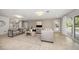 Bright living room featuring neutral decor, wood floors, and sliding doors to the backyard at 16 Hibiscus Rd, Belleair, FL 33756