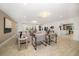 Spacious living room with neutral decor, wood floors, and access to both kitchen and outdoor area at 16 Hibiscus Rd, Belleair, FL 33756