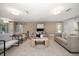Well-lit living area features neutral tones, a sliding barn door, and comfortable seating for guests at 16 Hibiscus Rd, Belleair, FL 33756