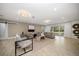 Bright living room featuring neutral decor, wood floors, and sliding doors to the backyard at 16 Hibiscus Rd, Belleair, FL 33756