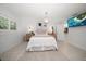 Bright main bedroom with a decorative chandelier, TV, neutral decor, and an adjoining bathroom at 16 Hibiscus Rd, Belleair, FL 33756