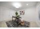 Bright office space with neutral decor, natural light, modern art, and a stylish black and white rug at 16 Hibiscus Rd, Belleair, FL 33756