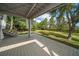 Expansive patio with a staircase, offering a serene view of the lush backyard and well-manicured landscaping at 16 Hibiscus Rd, Belleair, FL 33756