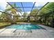 A refreshing screened-in pool surrounded by lush landscaping, perfect for outdoor relaxation and enjoyment at 16 Hibiscus Rd, Belleair, FL 33756