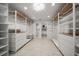 Bright walk-in closet with custom shelving and drawers, leading to the bedroom at 16 Hibiscus Rd, Belleair, FL 33756