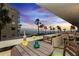 Enjoy the coastal sunset views from this balcony with seating around a small table with drinks at 17900 Gulf Blvd # 1B, Redington Shores, FL 33708