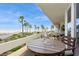 Enjoy ocean views from the spacious balcony with seating and beautiful palm trees at 17900 Gulf Blvd # 1B, Redington Shores, FL 33708