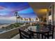 Relax on the balcony with beach views and seating around a small table for drinks and snacks at 17900 Gulf Blvd # 1B, Redington Shores, FL 33708