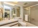 Clean bathroom with glass-enclosed shower, white sink vanity, and large mirror at 17900 Gulf Blvd # 1B, Redington Shores, FL 33708