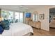 Bedroom with a TV, balcony access, and dresser at 17900 Gulf Blvd # 1B, Redington Shores, FL 33708