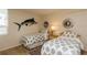 Comfortable bedroom featuring twin beds, side table, lamps, and unique marlin wall art at 17900 Gulf Blvd # 1B, Redington Shores, FL 33708