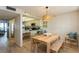 Open dining area connects to the kitchen and features a wooden table and bench at 17900 Gulf Blvd # 1B, Redington Shores, FL 33708