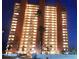 Exterior shot of the beachfront Redington Towers building at night with illuminated balconies at 17900 Gulf Blvd # 1B, Redington Shores, FL 33708