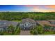 Aerial view of a two-story house surrounded by green trees in a suburban neighborhood at 18203 Pine Hammock Blvd, Lutz, FL 33548
