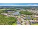 Expansive aerial shot of a neighborhood highlighting lake views and green spaces, offering serene living at 18203 Pine Hammock Blvd, Lutz, FL 33548
