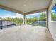 Home balcony view with tile flooring and covered overhead at 18203 Pine Hammock Blvd, Lutz, FL 33548