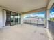 Home balcony view with tile flooring and covered overhead at 18203 Pine Hammock Blvd, Lutz, FL 33548