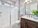 Bright bathroom with tiled shower and dark wood vanity at 18203 Pine Hammock Blvd, Lutz, FL 33548