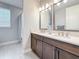 Stylish bathroom showcasing a double vanity with granite countertops and modern fixtures at 18203 Pine Hammock Blvd, Lutz, FL 33548