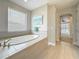 Bright bathroom with soaking tub and tile flooring at 18203 Pine Hammock Blvd, Lutz, FL 33548