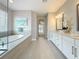 Bathroom with soaking tub, double vanity, granite countertops, and tile flooring at 18203 Pine Hammock Blvd, Lutz, FL 33548
