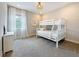 Bright bedroom featuring white bunk beds, soft carpet, and decorative wall mirror at 18203 Pine Hammock Blvd, Lutz, FL 33548