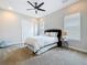 Bedroom with ceiling fan, carpet flooring and large windows at 18203 Pine Hammock Blvd, Lutz, FL 33548