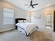 Bedroom with ceiling fan, carpet flooring and large windows at 18203 Pine Hammock Blvd, Lutz, FL 33548