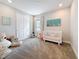 bedroom with large stuffed animal, closet, and white crib with colorful bedding at 18203 Pine Hammock Blvd, Lutz, FL 33548